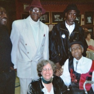Meeting the elders: singerJesse Fortune, in white, with Larry Taylor; Detroit Junior, piano entertainer, red vest,  Chicago Blues Exchange downtown 2004